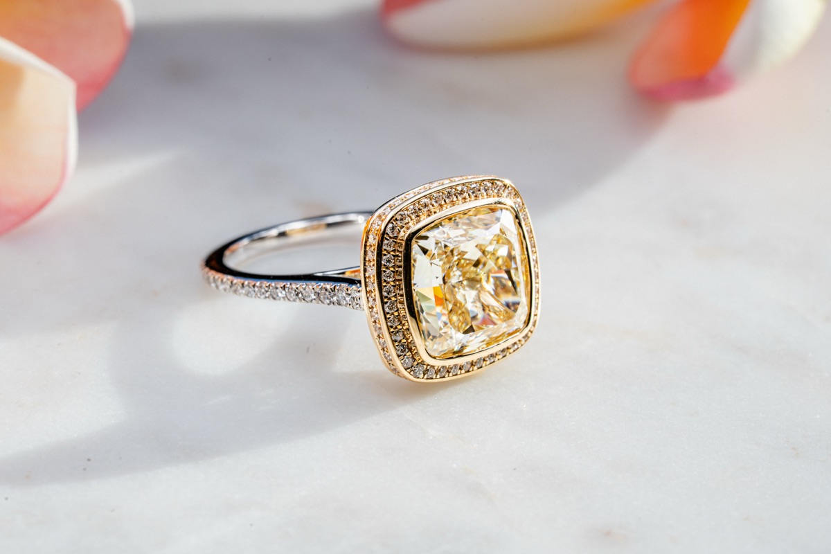 A yellow gold halo engagement ring.
